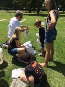 The Tremper children- Elsie, Carson, Tobin, and Brycen- helping their elderly great uncle clean off family grave markers at Belmont Memorial Park in Fresno.